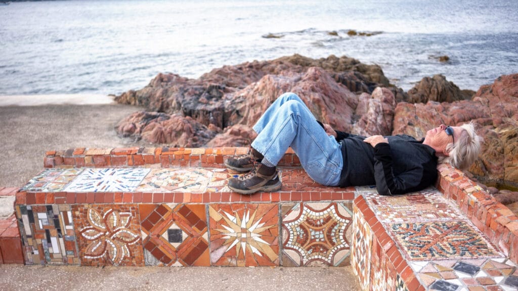 Baby Boomer Grey Nomad taking quick nap by the beach