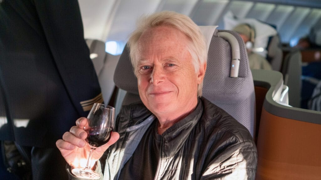 Baby Boomers on plane drinking wine in their Golden Years - retirement