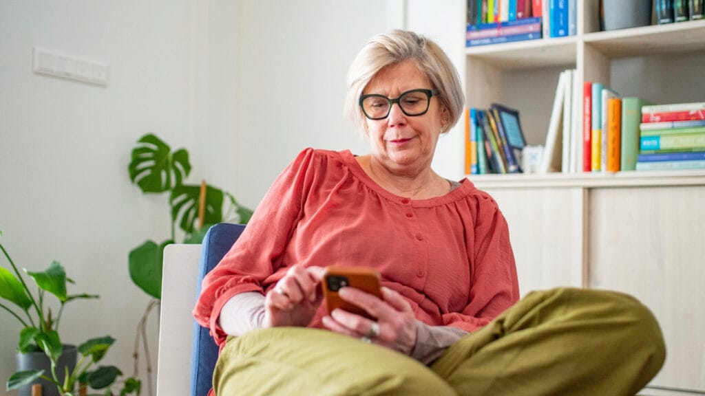 Baby Boomer using Facebook on her smart phone